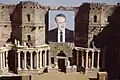 Assad portrait on ancient building.