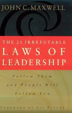 Three rectangles on top of each other, the top one black, the middle one red, and the bottom one gold, all with words on them, in gold, white, and black, respectively