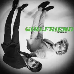 Upside down black and white picture of the band members, with an overlapping green album title