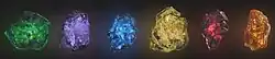 The six Infinity Stones floating in space. From left to right: Time (green), Power (purple), Space (blue), Mind (yellow), Reality (red), and Soul (orange)
