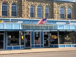 A blue drug store with a flag of the United States at the top.