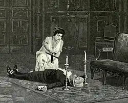The body of a man lies supine, with a woman, crucifix in hand, kneeling over him. A candle is placed to each side of his head.