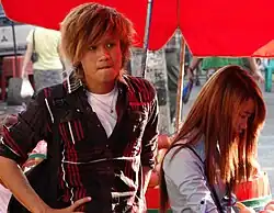 Image 80Teenagers in Yangon, Myanmar with trendy, dyed haircuts and slim fit, layered silhouettes inspired by East Asian and American trends, 2014. (from 2010s in fashion)