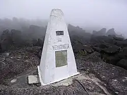 Border stone on the tripoint of Venezuela (foreground), Brazil, and Guyana located on Mount Roraima