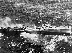 USS Fiske broken in two and sinking in the Atlantic Ocean on 2 August 1944 after she was torpedoed by the German submarine&nbsp;U-804. Note the men abandoning ship by walking down the side of her capsizing bow section.