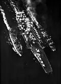 Altair (left) and the ammunition ship USS&nbsp;Nitro&nbsp;(AE-23) (right) conduct a simultaneous underway replenishment of stores and ammunition (respectively) of the attack aircraft carrier USS&nbsp;Forrestal&nbsp;(CVA-59) (center) in the Tyrrhenian Sea on 8 January 1965.