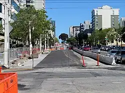An urban arterial with construction work occupying half the roadway
