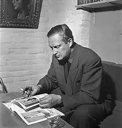 man sitting, reading a book