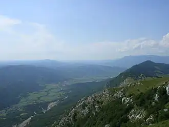 A photo showing a valley and a mountain
