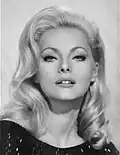 Virna Lisi, John's beautiful cousin whom he dodges