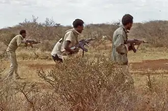 WSLF militant on center with AKM-63.