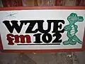 Photo of WZUE logo on a billboard, branded as "Zoo 102"