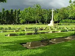 Image 68Chittagong War Cemetery is a Commonwealth War Graves Commission cemetery located at Dampara 22 kilometers north of the airport and 8 kilometers from the port. The burial area is surrounded by a large plantation. A tarmac lane leads from the entrance gate to the burial area which is entered through a metal gate flanked by two small brick chapels. Photo Credit: Hossain Toufique Iftekher