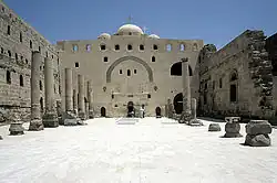 Ancient monastery complex showing massive stone walls and architectural elements reminiscent of Egyptian temple design