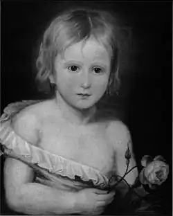 Black-and-white half-length portrait of a toddler, wearing a small shirt that is falling off of his body, revealing half of his chest. He has short blonde hair and is holding a rose.