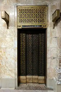 Photograph showing an ornately detailed elevator door