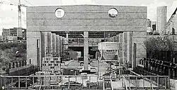 Concrete walls of a partially-below-ground station under construction