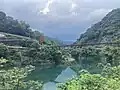 Wulai Suspension Bridge over Nanshi River with incoming storm