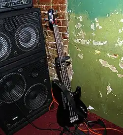 A stage set-up for an electric bass player shows a bass amplifier unit and two bass speaker cabinets.