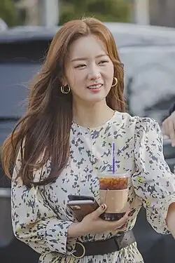 Yoon in white patterned dress in January 2020
