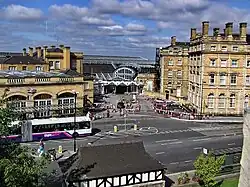 Station forecourt with hotel to the right
