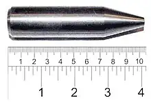 Shiny metallic cylinder with a sharpened tip. The overall length is 9&nbsp;cm and diameter about 2&nbsp;cm.