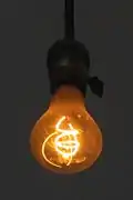 An incandescent light bulb's filament emitting light