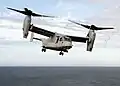 The MV-22 Osprey tiltrotor has a high disk loading, producing visible blade tip vortices.