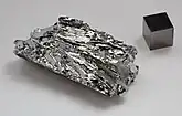 Molybdenum crystals and a 1&nbsp;cm3 molybdenum cube for comparison